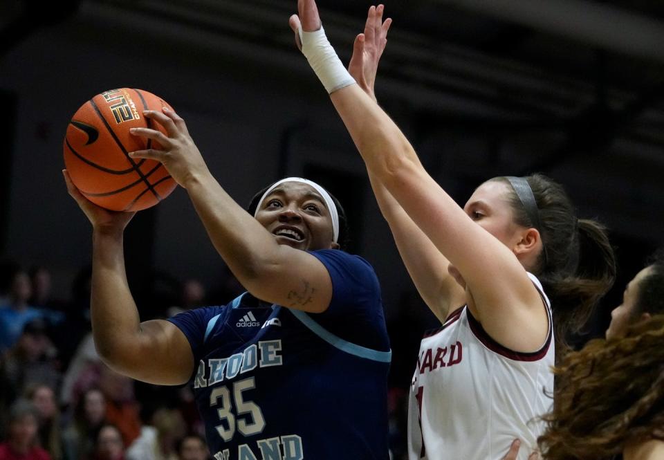Sayawni Lassiter lays the ball up against Harvard guard Maggie McCarthy in the first half.