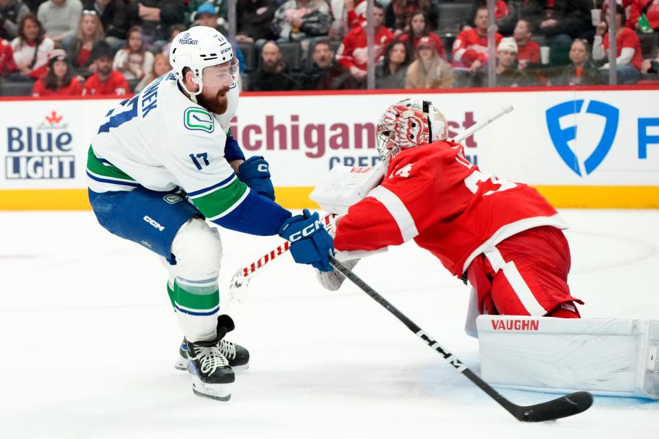 Vancouver Canucks defenseman Filip Hronek (17) scores on Detroit Red Wings goaltender Alex Lyon (34) in the second period at Little Caesars Arena in Detroit on Saturday, Feb. 10, 2024.