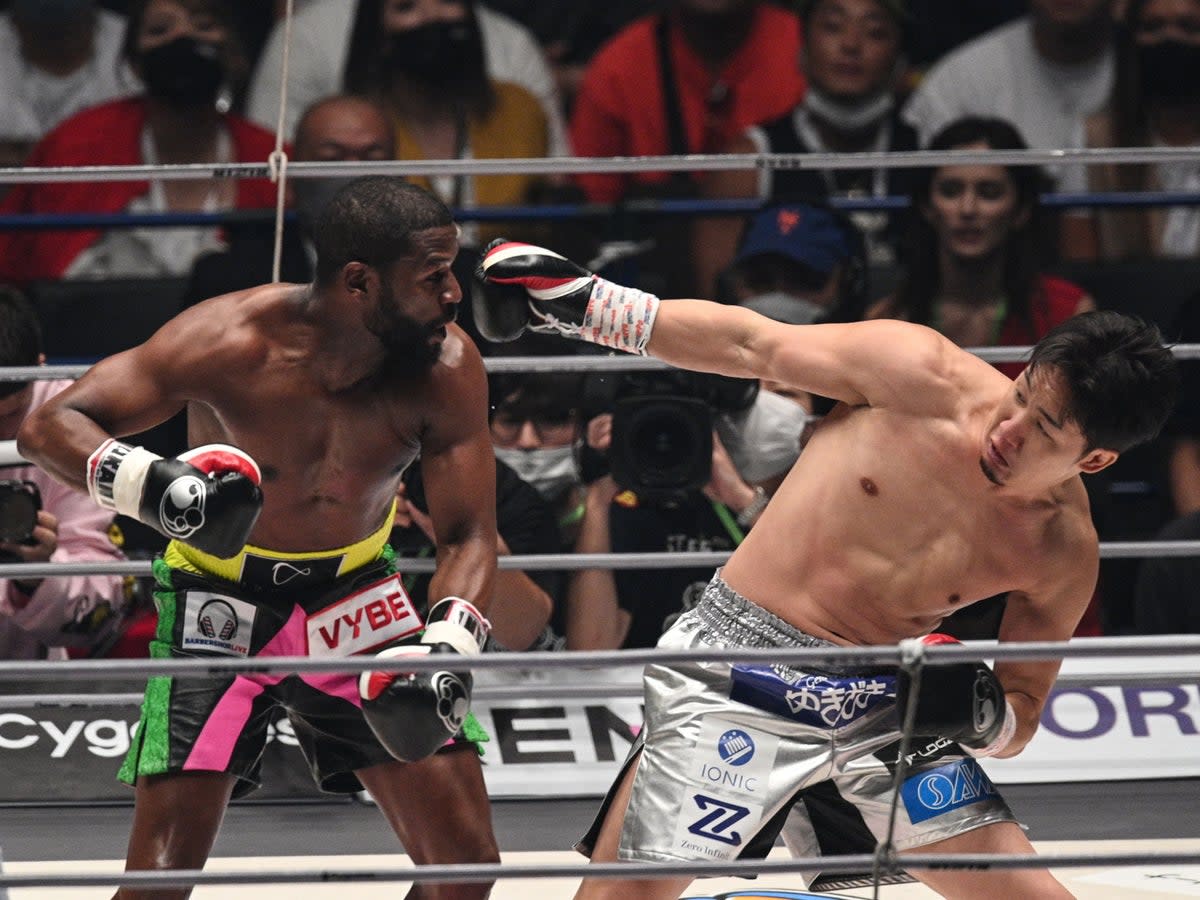 Floyd Mayweather (left) stopped Mikuru Asakura in the second of three scheduled rounds (AFP via Getty Images)