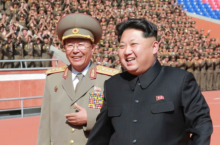 North Korean leader Kim Jong-Un (R) shares a light moment with then the chief of the Korean People's Army General Staff Ri Yong-Gil, in Pyongyang, in October 2015