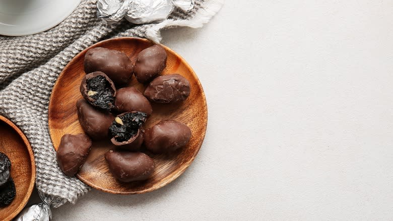 Chocolate covered prunes on plate