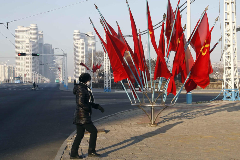 A person passes by a bouquet of Workers Party flags along a main street of the Central District in Pyongyang, North Korea, on Wednesday, Jan. 6, 2021. The Workers’ Party Congress is one of the North’s biggest propaganda spectacles and is meant to help leader Kim Jong Un show his people that he’s firmly in control and boost unity in the face of COVID-19 and other growing economic challenges. (AP Photo/Jon Chol Jin)