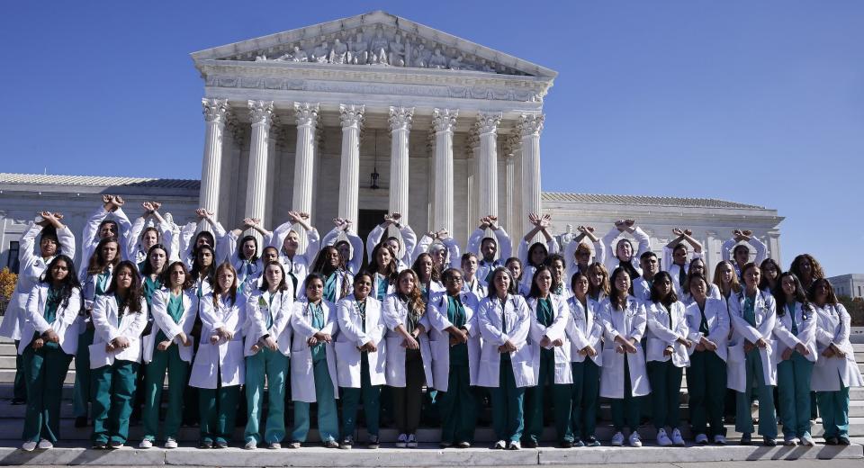 Doctors from across the US pose outside the US Supreme Court during a rally organized by Obstetricians for Reproductive Justice and Firebrand in Washington, DC, on Nov. 3, 2022.