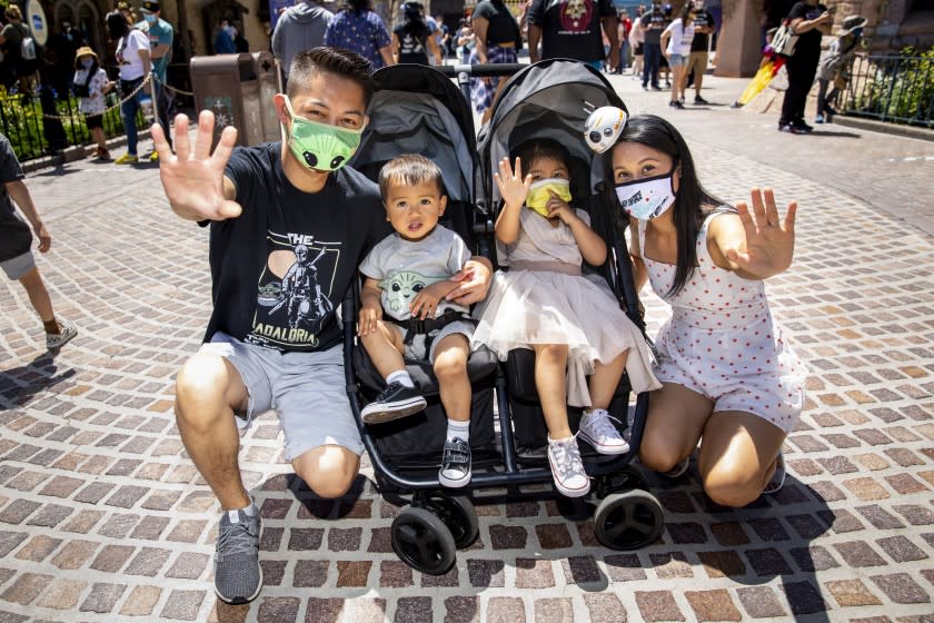 ANAHEIM, CA - May 03:The Tran family, from San Jose, including dad Don, Landon,1, Elyse,2 and mom Lili, wore their favorite Star Wars-themed outfits and used the force in their photo, at Disneyland Resort in Anaheim, CA, as visitors return to the park with covid-safety restrictions in place, including the park only being at 25% capacity, Monday, May 3, 2021. (Jay L. Clendenin / Los Angeles Times)