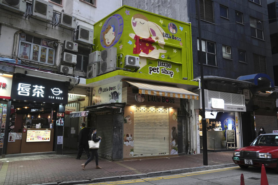 CORRECTS TO SAY 2,000 SMALL ANIMALS, NOT 2,000 HAMSTERS - A pet shop is closed after some pet hamsters were, authorities said, tested positive for the coronavirus, in Hong Kong, Tuesday, Jan. 18, 2022. Hong Kong authorities said Tuesday that they will kill about 2,000 small animals, including hamsters, after several tested positive for the coronavirus at the pet store where an employee was also infected. (AP Photo/Kin Cheung)