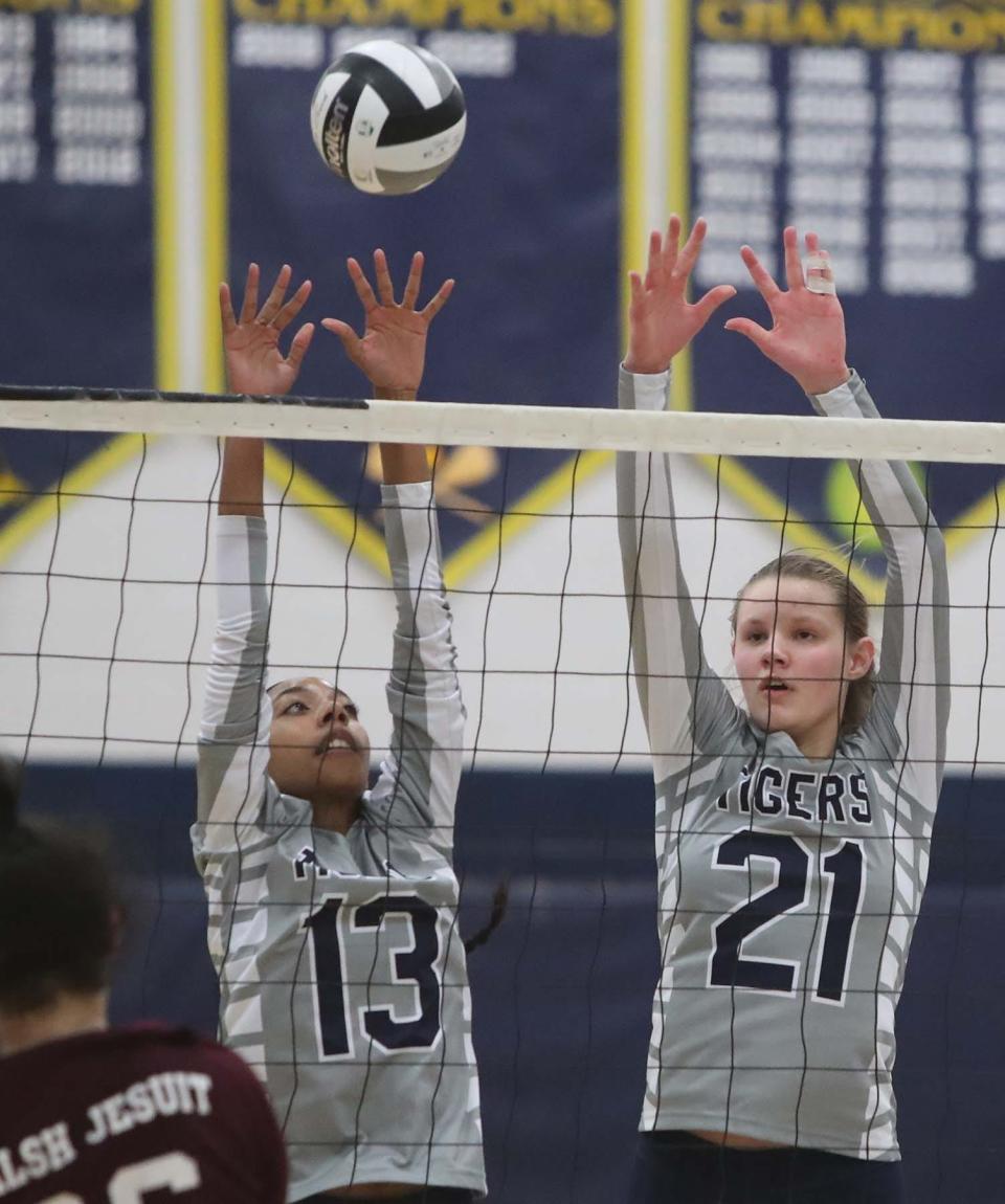 Twinsburg's Kendall Matlock, left, and Brooke Smith block a hit by Walsh Jesuit's Katherine Trzcinski during a Division I district semifinal on Oct. 25, 2022, in Solon.