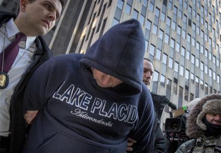 A hooded suspect is escorted by FBI agents from their Manhattan offices in New York February 11, 2014. REUTERS/Brendan McDermid