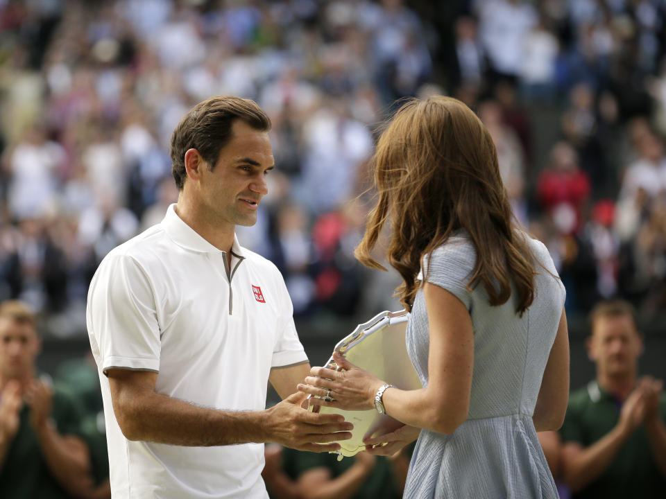 Switzerland's Roger Federer receives the runner up trophy from Kate, Duchess of Cambridge after losing to Serbia's Novak Djokovic in the men's singles final match of the Wimbledon Tennis Championships in London, Sunday, July 14, 2019. (AP Photo/Tim Ireland)