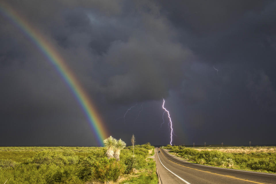 <p>A rainbow and lightning during a storm southeast of St. David, Ariz., on July 28, 2017. (Photo: Mike Olbinski/Caters News) </p>