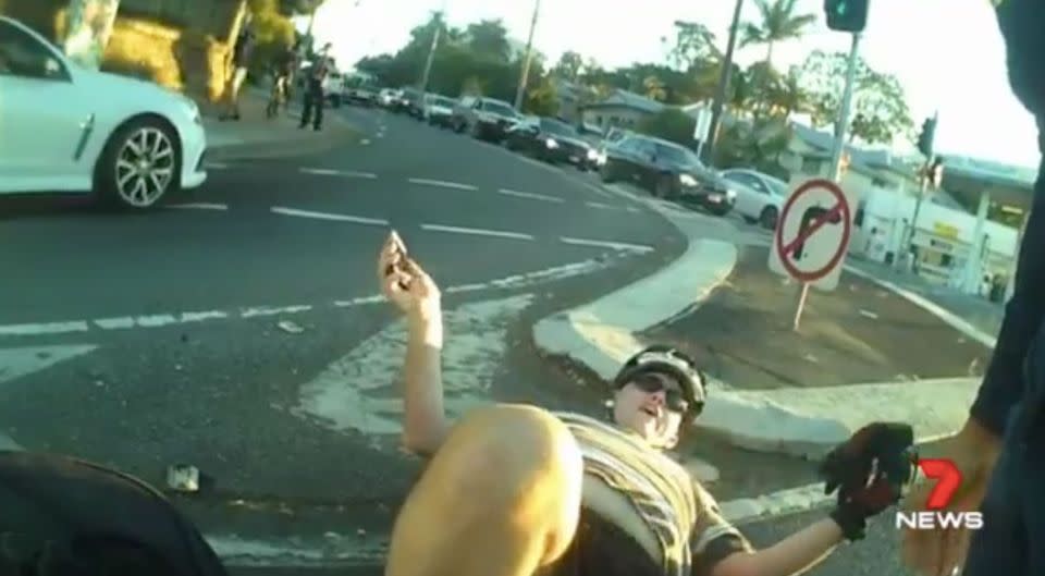 The driver offers up excuses while the cyclist languishes on the ground. Source: 7 News