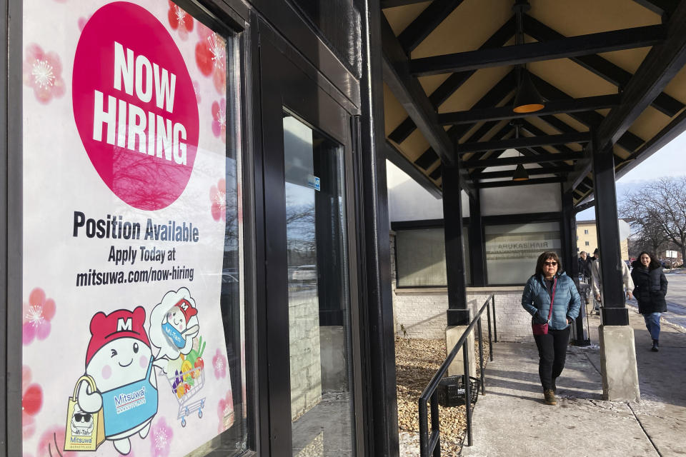 FILE - A hiring sign is displayed at a grocery store in Arlington Heights, Ill., Tuesday, Dec. 27, 2022. America’s employers added a solid 223,000 jobs in December, evidence that the economy remains healthy yet also a sign that the Federal Reserve may still have to raise interest rates aggressively to slow growth and cool inflation. (AP Photo/Nam Y. Huh, File)