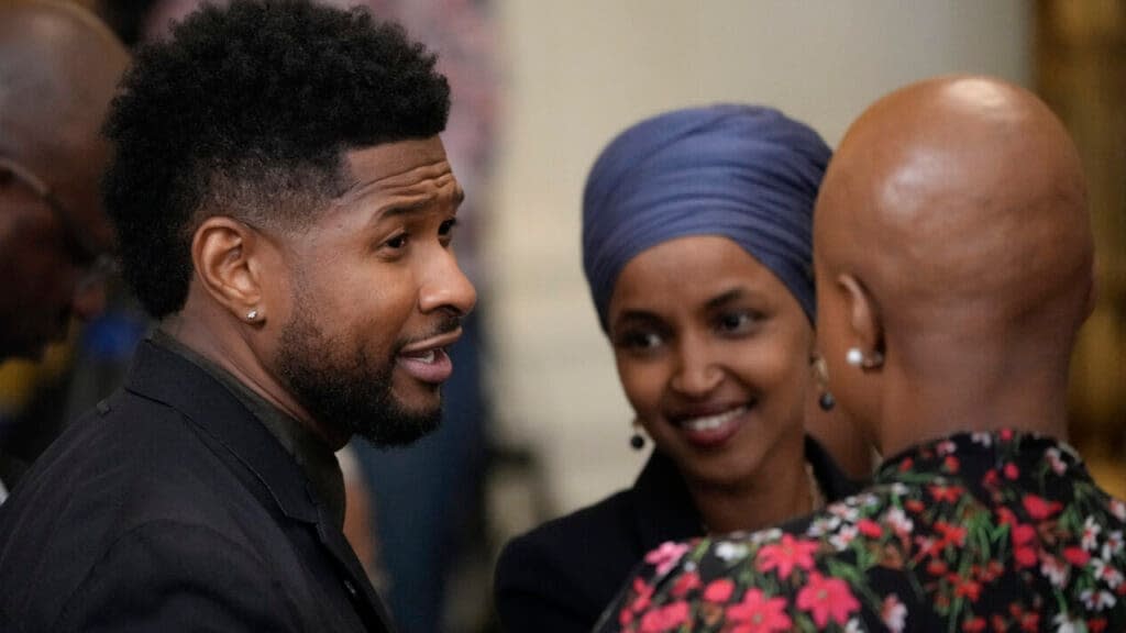 Usher speaks with Rep. Ilhan Omar (D-MN) and Rep. Ayanna Pressley, theGrio.com