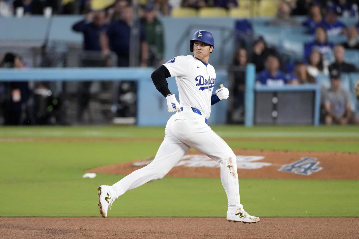 Los Angeles Dodgers' Shohei Ohtani rounds second as Mookie Betts flies out during the third inning of a baseball game against the Colorado Rockies, Friday, Sept. 20, 2024, in Los Angeles. (AP Photo/Mark J. Terrill)