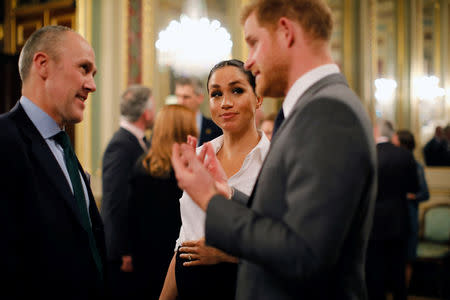 Britain's Prince Harry and Meghan, Duchess of Sussex, meet guests during a pre-ceremony reception before the Endeavour Fund Awards in the Drapers' Hall in London, Britain February 7, 2019. Tolga Akmen/Pool via REUTERS