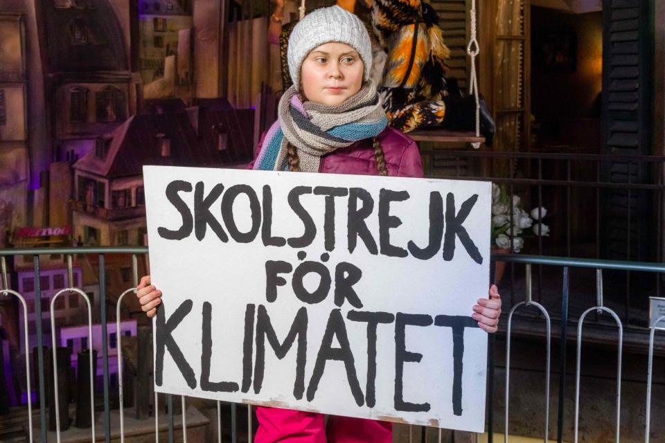 The waxwork of Greta Thunberg carries her famous placard reading 'school strike for the climate' (dpa/AFP via Getty Images)