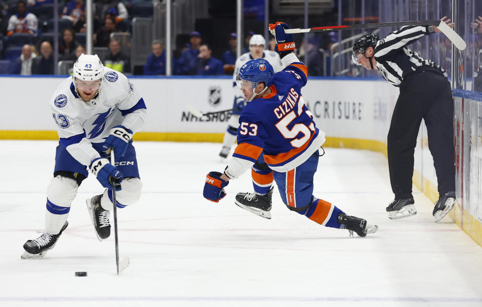 Tampa Bay Lightning defenseman Darren Raddysh (43) skates with the puck against New York Islanders center Casey Cizikas (53) during the second period of an NHL hockey game, Thursday, Feb. 8, 2024, in New York. (AP Photo/Noah K. Murray)