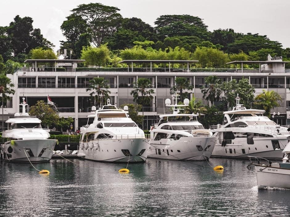 Yachts moored behind homes on Sentosa Island.