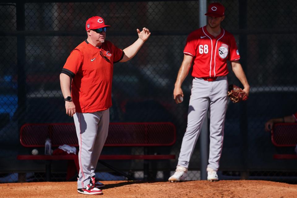 Cincinnati Reds pitching coach Derek Johnson instructs Cincinnati Reds starting pitcher Carson Spiers (68) in the bullpen during spring training workouts, Thursday, Feb. 15, 2024, at the team’s spring training facility in Goodyear, Ariz.