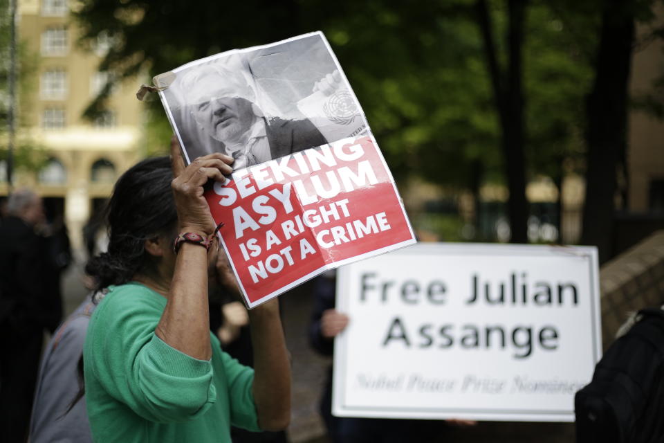 Protesters outside court as WikiLeaks founder Julian Assange will appear in court to be sentenced on charges of jumping British bail seven years ago, in London, Wednesday May 1, 2019. Assange was arrested at the Ecuadorian embassy April 11, after his political asylum was withdrawn. (AP Photo/Matt Dunham)