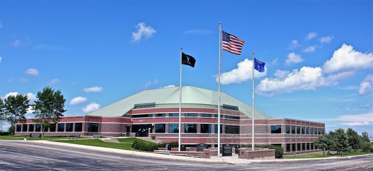 Flags flap in the wind in front of the Ozaukee County Courthouse.