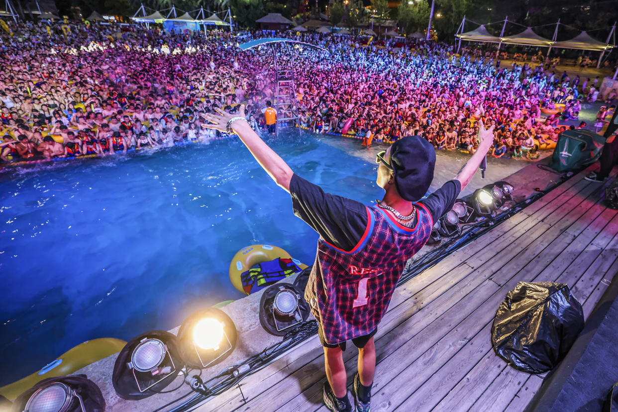 This photo taken on August 15, 2020 shows people watching a performance as they cool off in a swimming pool in Wuhan in China's central Hubei province. (Photo by STR / AFP) / China OUT (Photo by STR/AFP via Getty Images)