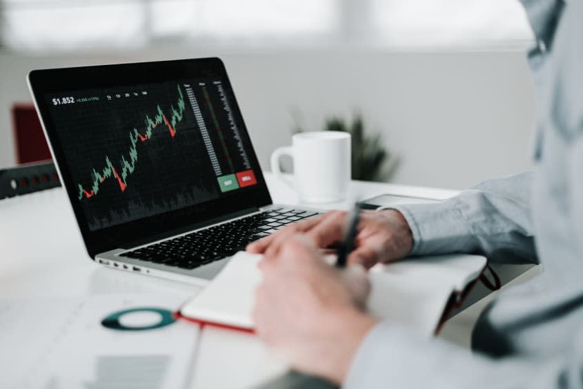 Man using laptop for analyzing stock market data