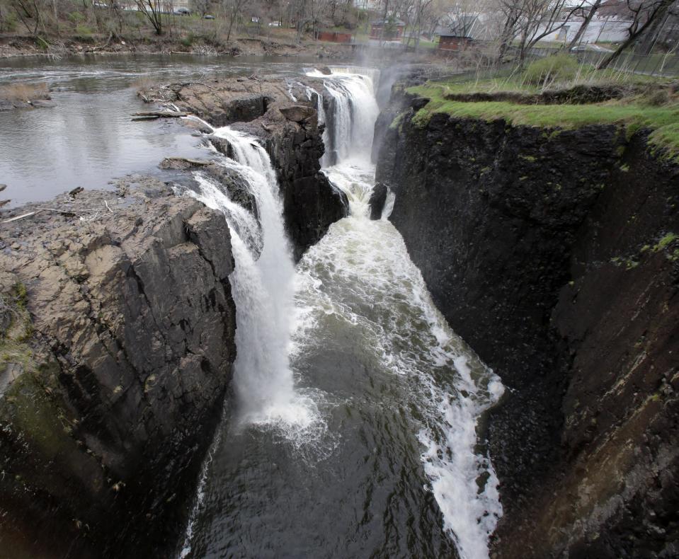 Water rushes over the Great Falls in Paterson, N.J. on Saturday, April 13, 2013. Alexander Hamilton, the nation's first treasury secretary, envisioned harnessing the power of the falls to create the nation's first planned industrial city in Paterson, helping to transform America from an agrarian society into an industrial powerhouse capable of breaking free from British control. Generations of immigrant workers were employed in factories powered by energy from the Great Falls. The nearby dilapidated Art Deco baseball stadium, Hinchliffe Stadium, earned designation in March as a national landmark - less than two years after the nearby Great Falls, a powerful 77-foot waterfall that helped fuel the Industrial Revolution, became a national park. (AP Photo/Mel Evans)