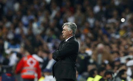 Real Madrid coach Carlo Ancelotti watches his team play Bayern Munich in their Champions League semi-final first leg soccer match at Santiago Bernabeu stadium in Madrid April 23, 2014. REUTERS/Sergio Perez