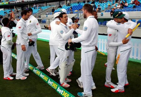 Cricket - Australia v South Africa - Second Test cricket match - Bellerive Oval, Hobart, Australia - 15/11/16. South Africa's captain Faf du Plessis hugs team mates as they celebrate after defeating Australia. REUTERS/David Gray