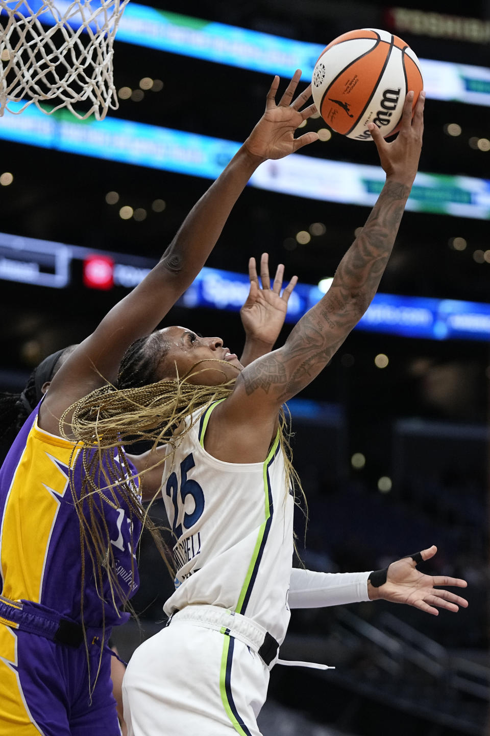 Minnesota Lynx guard Tiffany Mitchell, right, shoots as Los Angeles Sparks forward Chiney Ogwumike defends during the first half of a WNBA basketball game Tuesday, June 20, 2023, in Los Angeles. (AP Photo/Mark J. Terrill)