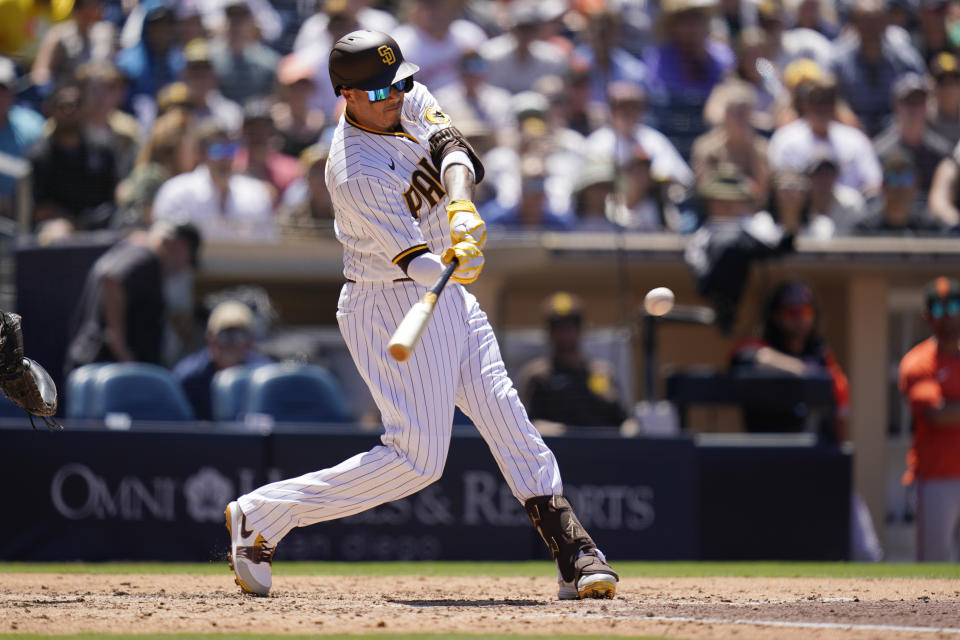 San Diego Padres' Manny Machado hits a two-run double during the third inning of a baseball game against the San Francisco Giants, Wednesday, Aug. 10, 2022, in San Diego. (AP Photo/Gregory Bull)