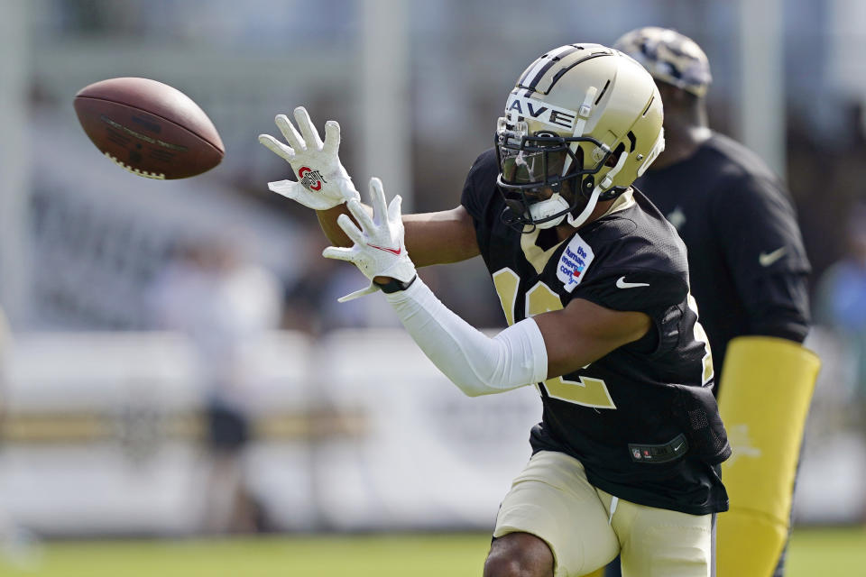 New Orleans Saints wide receiver Chris Olave (12) runs through drills during training camp at their NFL football training facility in Metairie, La., Thursday, Aug. 4, 2022. (AP Photo/Gerald Herbert)