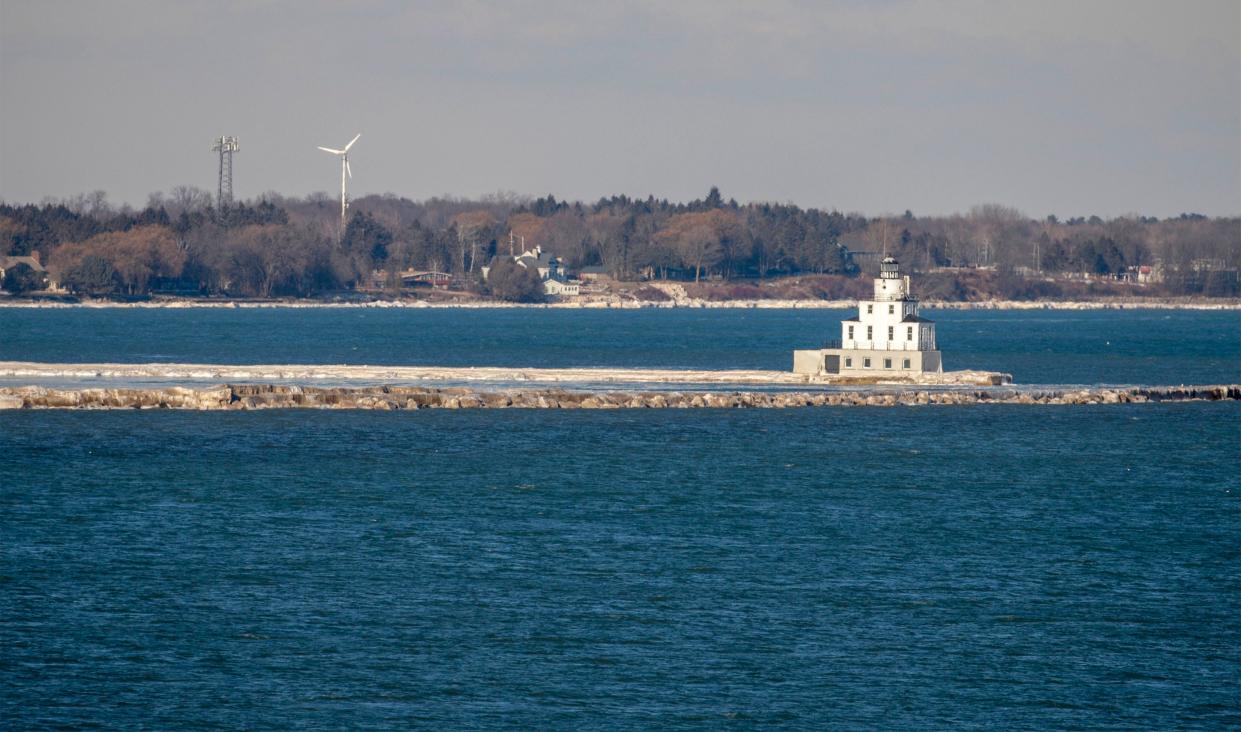 Open Lake Michigan water appears around the Manitowoc lighthouse, Friday, January 21, 2022, in Manitowoc, Wis.