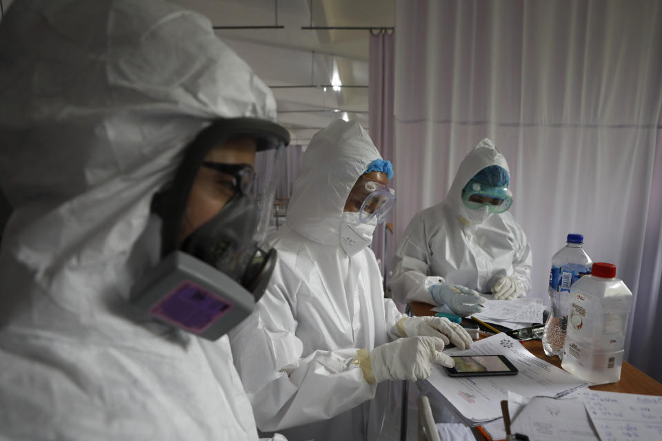 Medical staff wearing protective gear tend to a patient in the women's ward of a COVID-19 hospital at Military Camp 1, Naucalpan, Mexico State, part of the Mexico City metropolitan area, Tuesday, June 23, 2020. Mexico ranks seventh globally in COVID-19 deaths and third in its mortality rate among the 20 currently most affected countries, according to Johns Hopkins University. (AP Photo/Rebecca Blackwell)