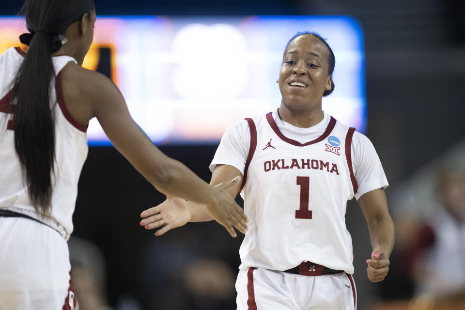 Oklahoma guard Nevaeh Tot (1) celebrates her basket with guard Kennady Tucker (4) during the second half of the team's first-round college basketball game against Portland in the women's NCAA Tournament, Saturday, March 18, 2023, in Los Angeles. (AP Photo/Kyusung Gong)