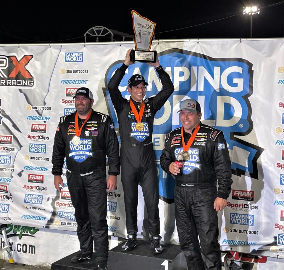 Helio Castroneves (middle) lifts the winner's trophy on the top of the podium after finishing first at the SRX season opener on Saturday, June 18 from Five Flags Speedway. Bubba Pollard (left) finished second while Ryan Newman (right) placed third.