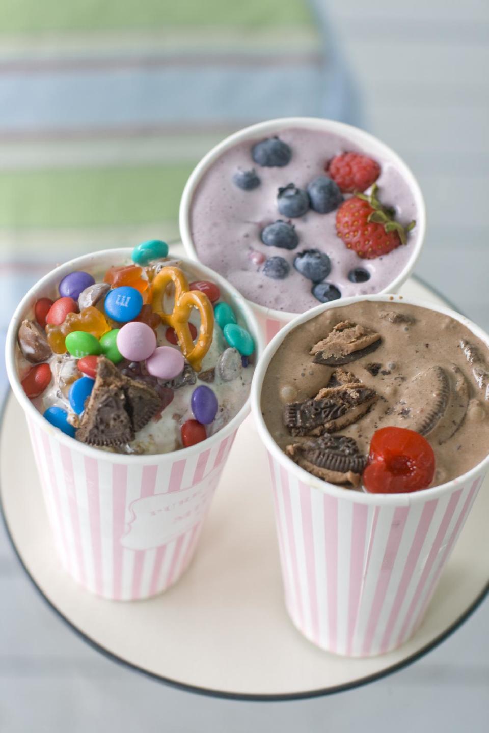 This July 22, 2013 photo shows, from top clockwise, Berry Basket, Dark Horse Cherry and Concession Stand DIY ice cream flurries in Concord, N.H. (AP Photo/Matthew Mead)