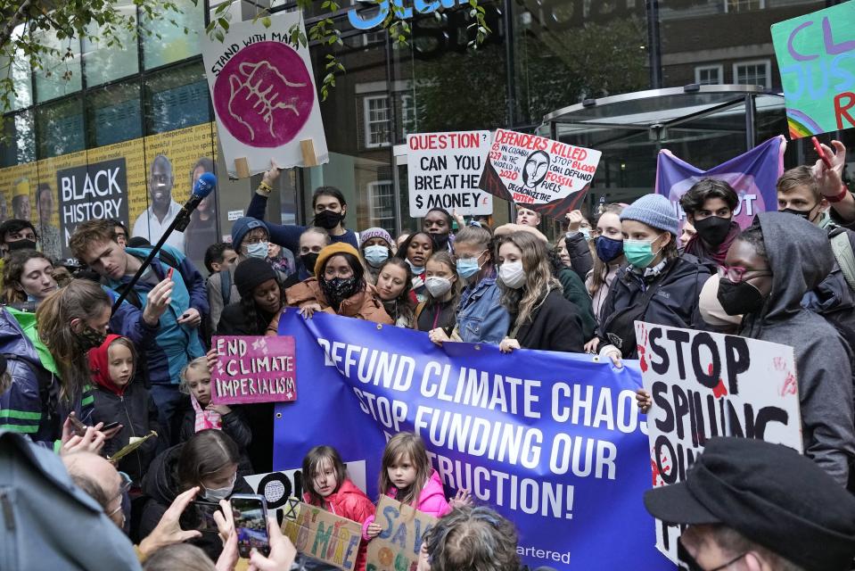 FILE - Climate activist Greta Thunberg, center, demonstrates with others in front of the Standard and Chartered Bank during a climate protest in London, England, Oct. 29, 2021. AP Photo/Frank Augstein, File)