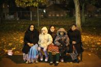 LEICESTER, UNITED KINGDOM - NOVEMBER 13: A family wraps up against the cold to watch fireworks during the Hindu festival of Diwali on November 13, 2012 in Leicester, United Kingdom. Up to 35,000 people attended the Diwali festival of light in Leicester's Golden Mile in the heart of the city's asian community. The festival is an opportunity for Hindus to honour Lakshmi, the goddess of wealth and other gods. Leicester's celebrations are one of the biggest in the world outside India. Sikhs and Jains also celebrate Diwali. (Photo by Christopher Furlong/Getty Images)