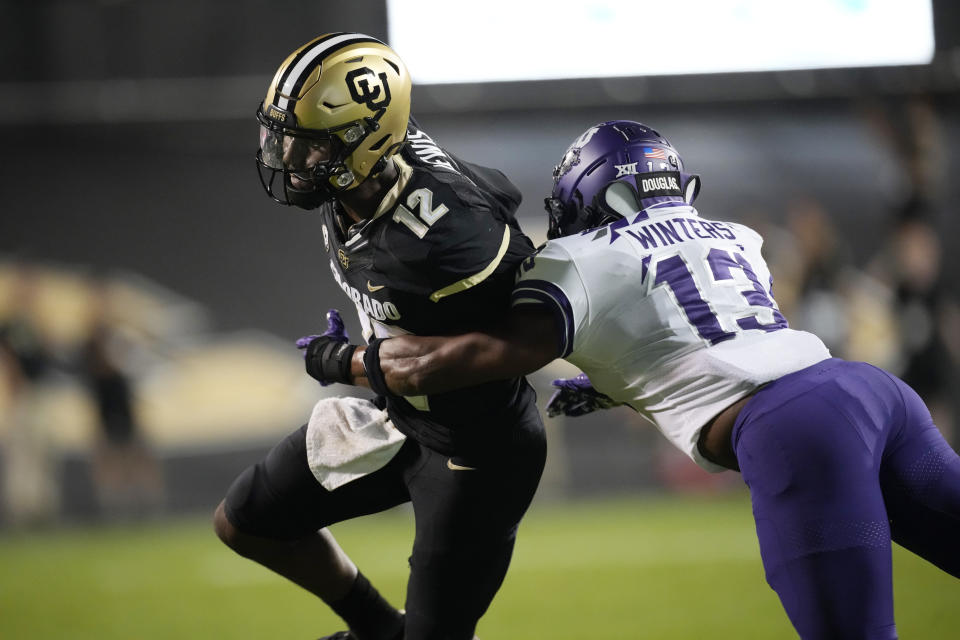 TCU linebacker Dee Winters, right, tackles Colorado quarterback Brendon Lewis during the first half of an NCAA college football game Friday, Sept. 2, 2022, in Boulder, Colo. (AP Photo/David Zalubowski)