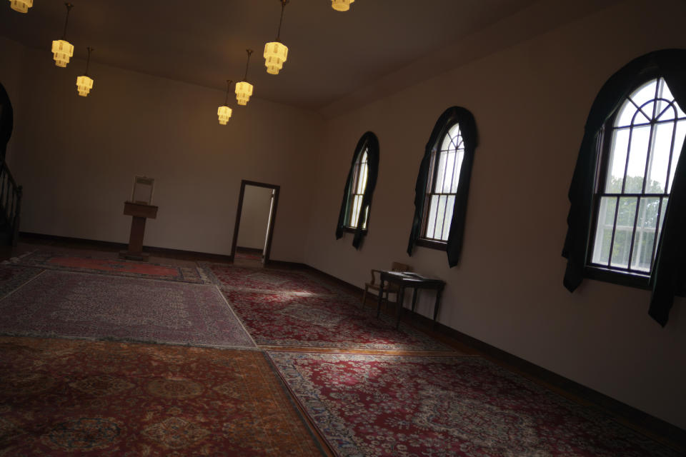 Light gleams through the windows at the historic Al-Rashid Mosque, believed to be the oldest in Canada, Saturday, July 16, 2022, in Edmonton, Alberta. The original red-brick structure now stands in the city's heritage park. (AP Photo/Jessie Wardarski)