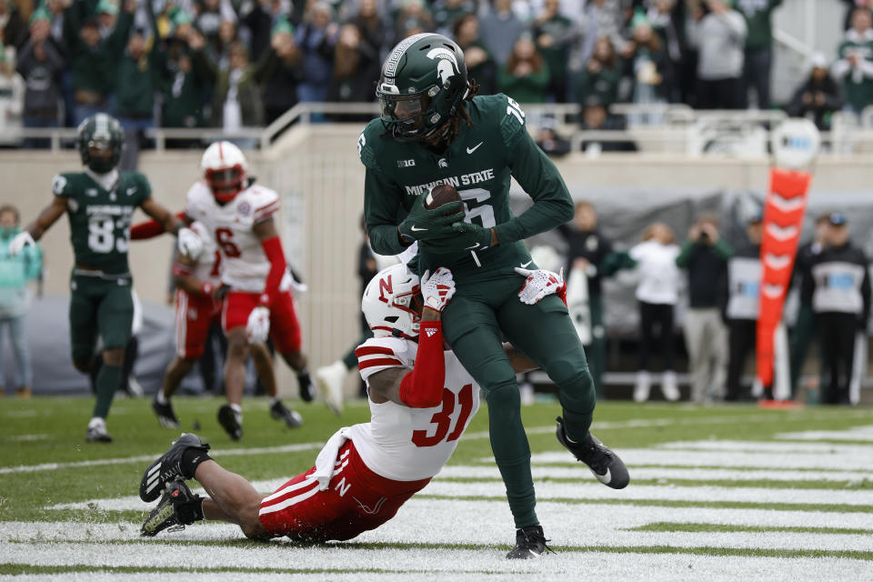 Michigan State wide receiver Christian Fitzpatrick, right, catches a pass for a touchdown against Nebraska defensive back Tommi Hill (31) during the first half of an NCAA college football game, Saturday, Nov. 4, 2023, in East Lansing, Mich. (AP Photo/Al Goldis)