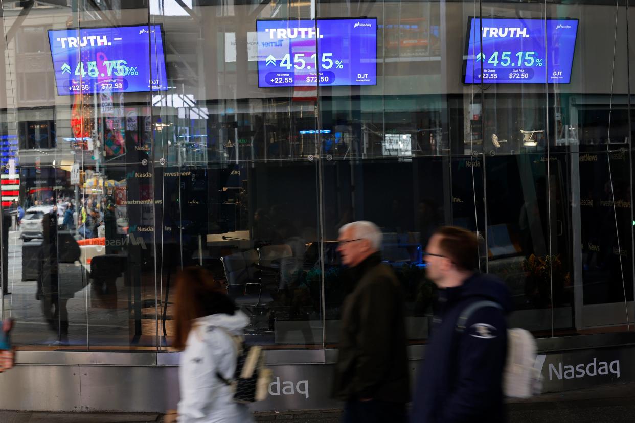 Trump Media & Technology Group stock market trading information is seen on a television at the Nasdaq Marketplace on March 26 in New York City. Trump Media & Technology Group, the owner of struggling social media platform Truth Social, owned by former President Donald Trump, began trading as a public company at Nasdaq's opening bell under the ticker symbol DJT.