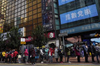 People queue up to purchase face masks outside a shop in Hong Kong, Monday, Jan. 27, 2020. Hong Kong announced it would bar entry to visitors from the mainland province at the center of the outbreak of a viral disease. Travel agencies were ordered to cancel group tours nationwide following a warning the virus's ability to spread was increasing. (AP Photo/Vincent Yu)