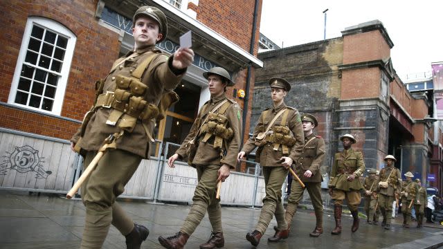 Actors dressed as World War One soldiers walk silently in the streets near Waterloo Station.