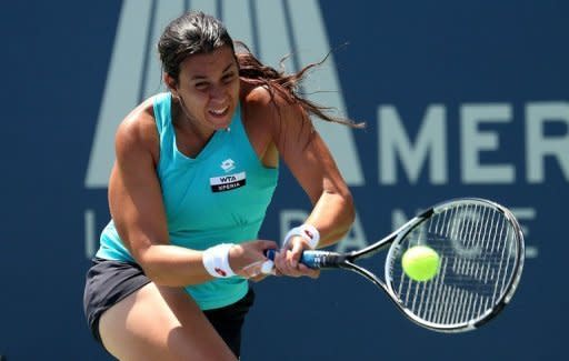 France's Marion Bartoli returns a shot to Slovakia's Dominika Cibulkova during their Mercury Insurance Open final on July 22. "I wish her good luck at the Olympics," Bartoli said. "I fought hard in my previous matches, today I just came up a bit short."