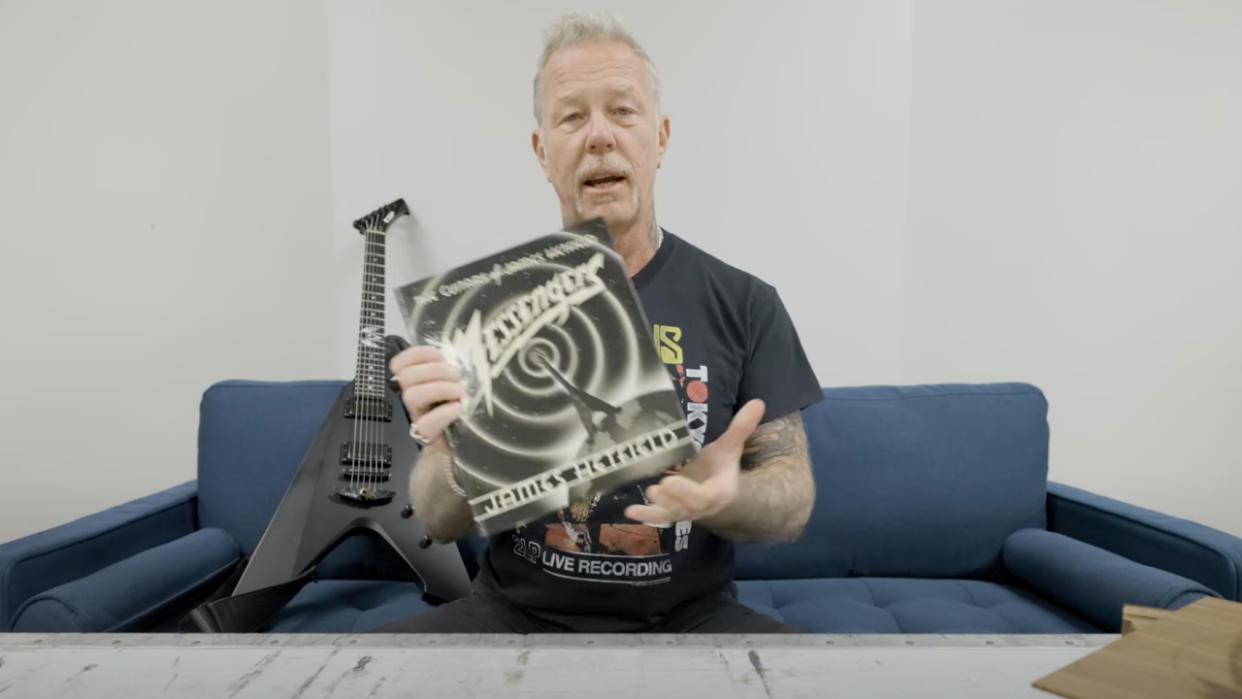  James Hetfield holds his new guitar book. 