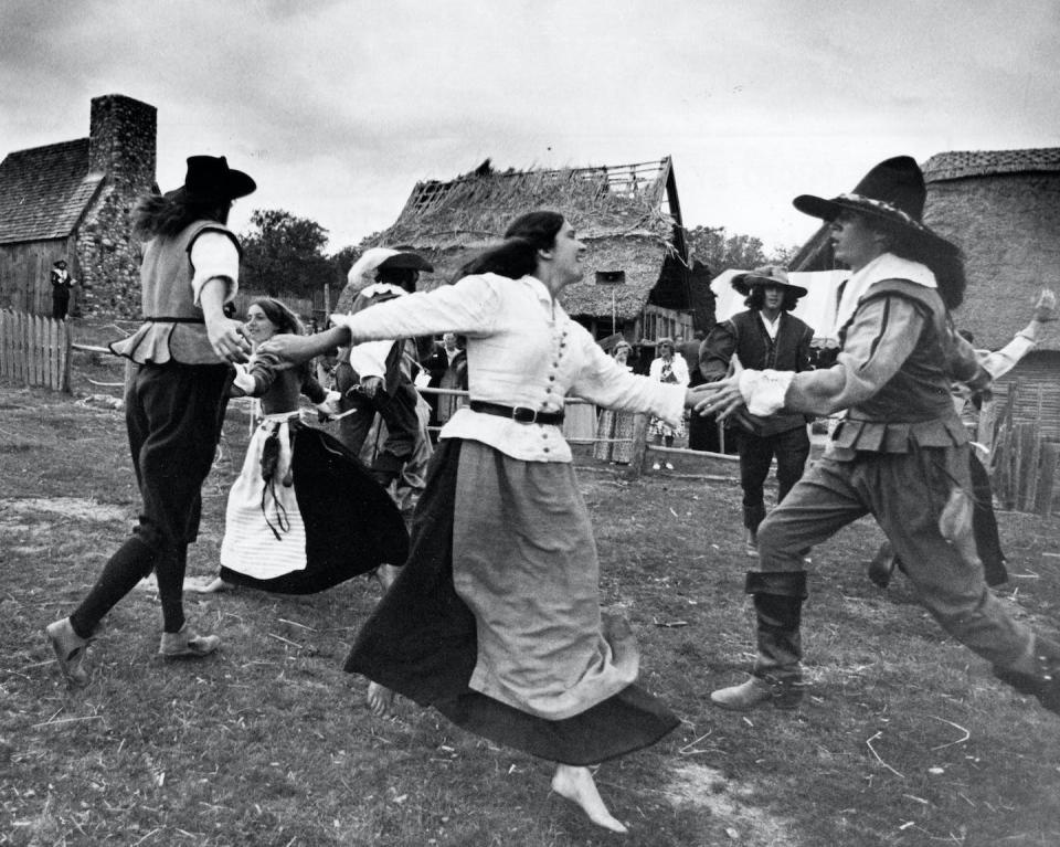 People in period clothing dance during a reenactment of life in Plymouth Plantation. <a href="https://www.gettyimages.com/detail/news-photo/people-in-period-clothing-dance-during-an-reunion-dinner-of-news-photo/538831584?adppopup=true" rel="nofollow noopener" target="_blank" data-ylk="slk:John Blanding/The Boston Globe via Getty Images;elm:context_link;itc:0;sec:content-canvas" class="link ">John Blanding/The Boston Globe via Getty Images</a>