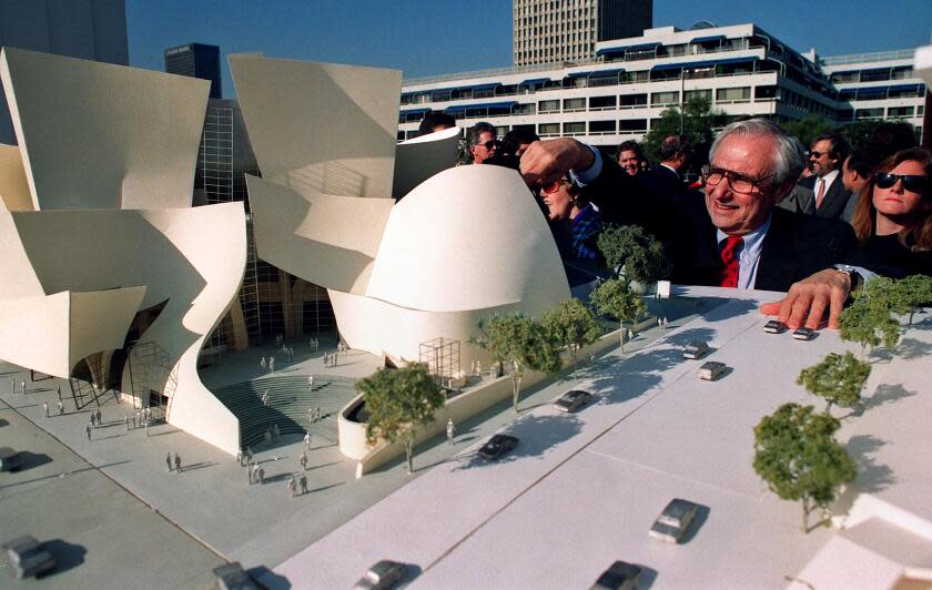 Architect Frank Gehry looks over a model of the Walt Disney Concert Hall during groundbreaking ceremonies in 1992.