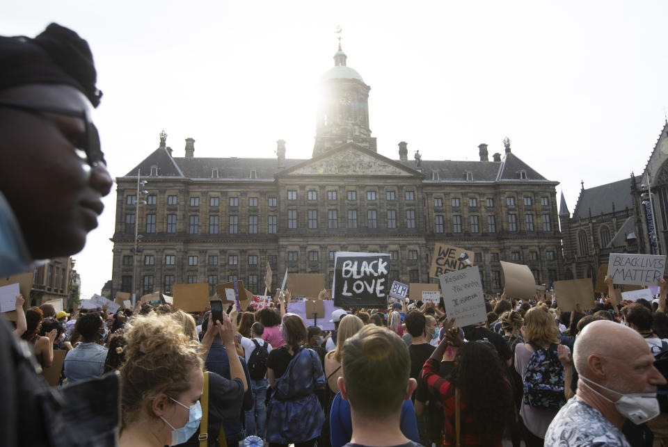 People take part in a Black Lives Matter protest in front of the Royal Palace on Dam Square in Amsterdam, Netherlands, Monday, June 1, 2020, to protest against the recent killing of George Floyd, a black man who died in police custody in Minneapolis, U.S.A., after being restrained by police officers on Memorial Day. (AP Photo/Peter Dejong)